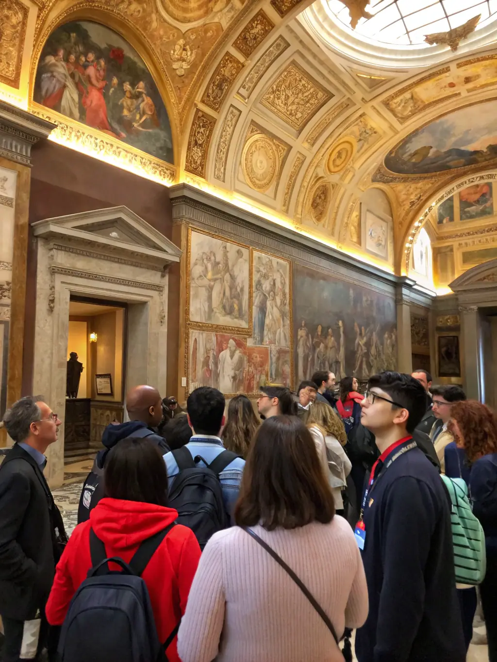 A photograph capturing a guided tour of the abbatiale in Montsalvy, with a focus on the architectural details and historical significance being explained by the guide to a group of attentive tourists.